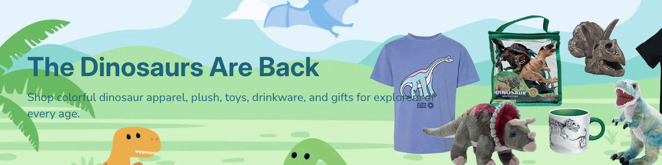 Colorful banner with dinosaur plush toys, a dinosaur T-shirt, mugs, and a toy set displayed on a cartoon landscape with green hills, trees, and dinosaur illustrations. Text: The Dinosaurs Are Back..