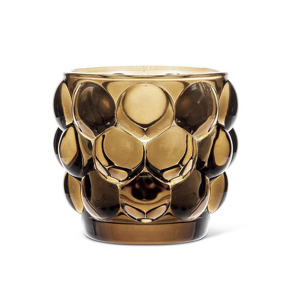 The Bubble Votive - Brown features a textured brown glass with large, raised circular patterns around the sides, exuding modern elegance against a plain white background.