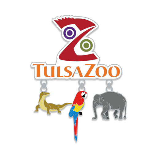 The Tulsa Zoo Dangle Magnet features a white background and three hanging charms—a Komodo dragon, colorful macaw, and gray elephant—making it a perfect souvenir that celebrates wildlife conservation.