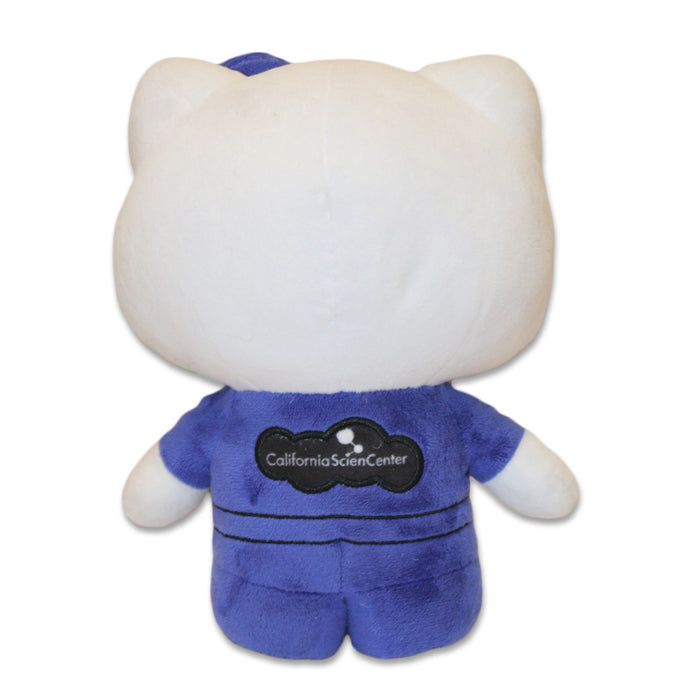 Hello Kitty Pilot Plush with cat-like ears in a blue aviator outfit, featuring a black California Science Center logo on the back. Displayed from behind on a white background—a perfect gift for aspiring young pilots.