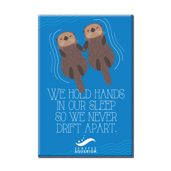 Seattle Aquarium Hold Hands Magnet: Features two sea otters holding hands on the water with "We hold hands in our sleep so we never drift apart" and the Seattle Aquarium logo—a perfect ocean-themed gift.
