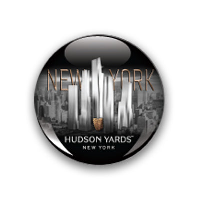 The Hudson Yards Glass Dome Magnet showcases silver skyscrapers with “NEW YORK” boldly displayed in the background and “HUDSON YARDS NEW YORK” in crisp white lettering below, all set against a dramatic cityscape—making this striking magnet the perfect New York City souvenir.