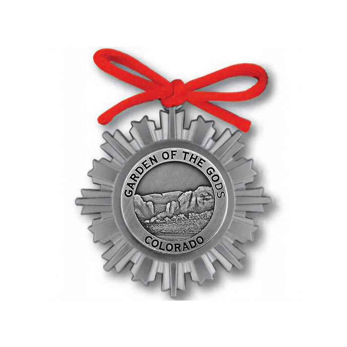 The Garden of the Gods Pewter Ornament showcases a striking sunburst motif and an eye-catching red ribbon, with the iconic rock formations at its heart. Embellished with the text “GARDEN OF THE GODS COLORADO,” this ornament is an ideal Colorado keepsake for anyone who appreciates natural beauty.
