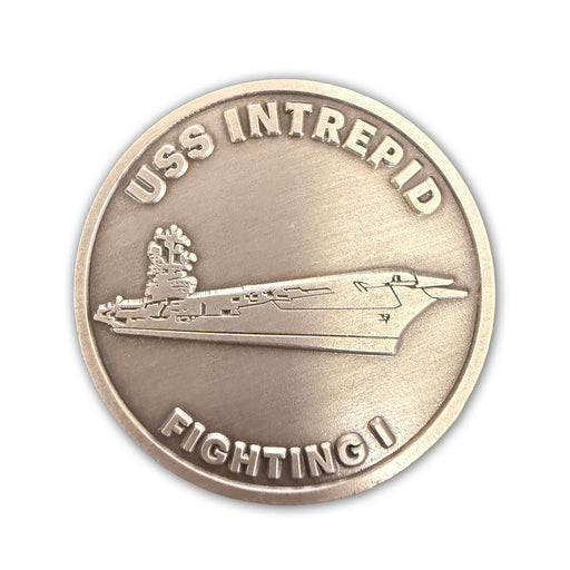 The Intrepid Museum Challenge Coin is a round metallic coin featuring a raised image of an aircraft carrier. “USS INTREPID” is inscribed along the top edge, with “FIGHTING I” at the bottom. With its plain background, this keepsake makes an ideal souvenir for visitors to the Intrepid Museum.