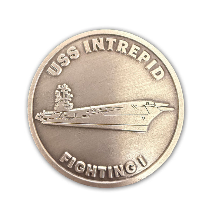 The Intrepid Museum Challenge Coin is a round metallic coin featuring a raised image of an aircraft carrier. “USS INTREPID” is inscribed along the top edge, with “FIGHTING I” at the bottom. With its plain background, this keepsake makes an ideal souvenir for visitors to the Intrepid Museum.