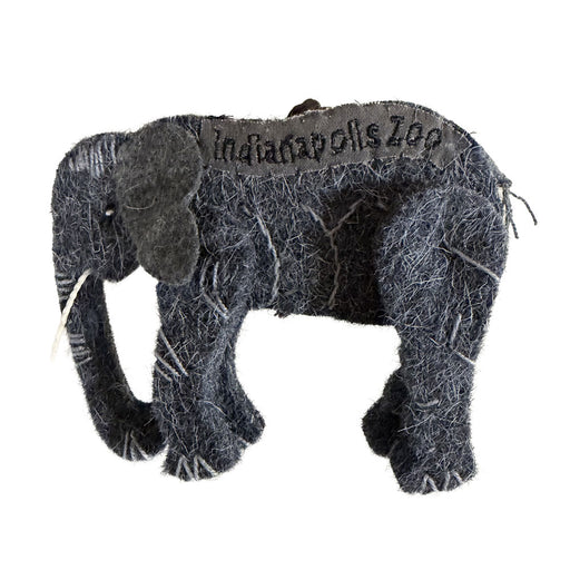 The Indianapolis Zoo Wool Elephant Ornament is a small, gray felt decoration with "Indianapolis Zoo" stitched on its back. Featuring visible white thread seams and a soft fabric texture, this charming piece celebrates the zoo’s dedication to wildlife conservation.