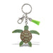 The Texas State Aquarium Sparkle Sea Turtle Keychain features a green rhinestone turtle charm, silver clasp, metal ring, and a small green tassel—an ocean-inspired accessory set against a white background.