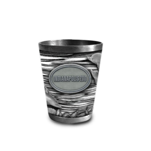 The Indianapolis Zoo Dolphin Metal Shot Glass is a silver-colored shot glass decorated with dolphin and water designs, featuring an oval emblem that reads "Indianapolis Zoo"—making it an ideal keepsake for collectors and animal lovers.