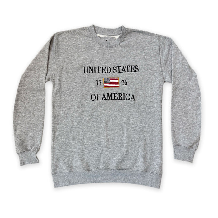 The United States Icon Crew Sweatshirt is a gray patriotic top with "UNITED STATES OF AMERICA," an American flag, and "1776" printed across the front—ideal apparel for anyone who loves American history.