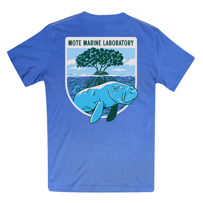 The Mote Marine Laboratory Manatee Organic T-Shirt is crafted from soft organic cotton and features a prominent back patch reading “Mote Marine Laboratory.” Its design highlights an illustrated manatee swimming by mangroves beneath a blue sky, celebrating marine conservation.