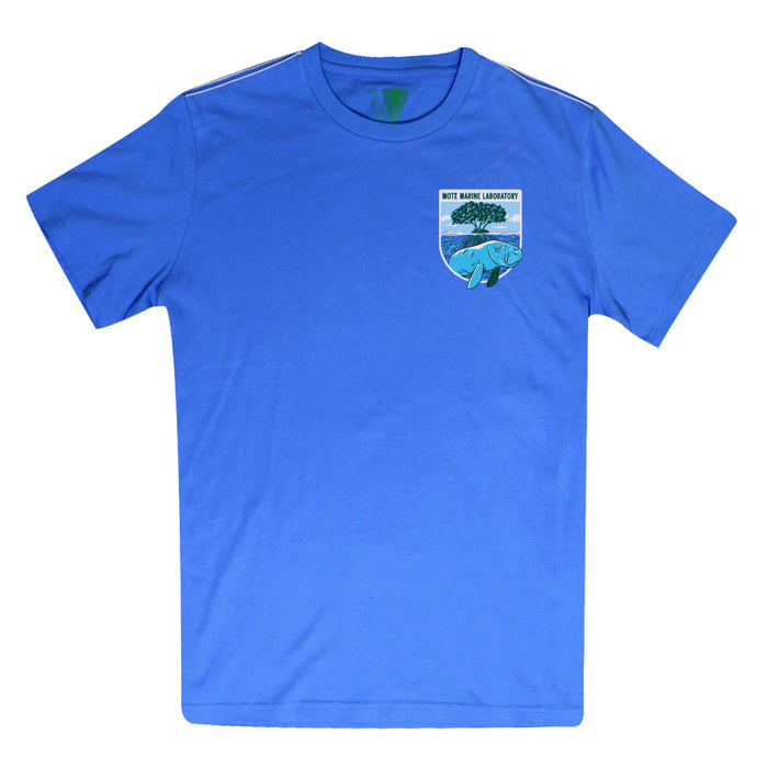 The Mote Marine Laboratory Manatee Organic T-Shirt is a blue organic cotton tee featuring a small patch on the left chest with an ocean scene, a manatee, and text that reads “Mote Marine Laboratory”—ideal for anyone passionate about marine conservation.