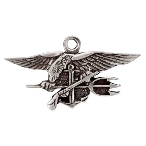 The Navy SEAL Museum Pewter Ornament is a handcrafted silver pin depicting an eagle with outstretched wings holding a trident, anchor, and flintlock pistol—an iconic symbol of the U.S. Navy SEALs that is also featured at the Navy SEAL Museum.