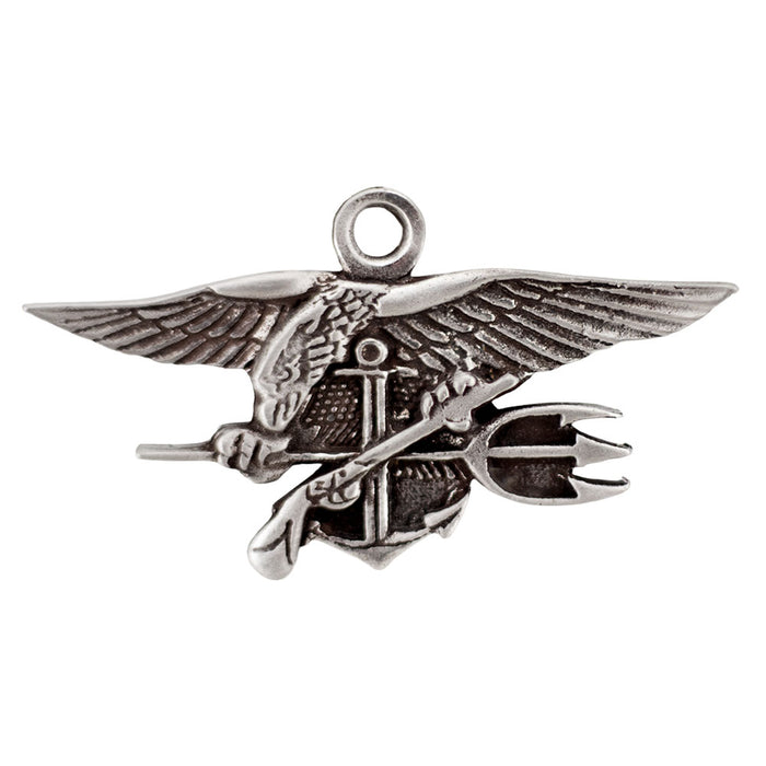 The Navy SEAL Museum Pewter Ornament is a handcrafted silver pin depicting an eagle with outstretched wings holding a trident, anchor, and flintlock pistol—an iconic symbol of the U.S. Navy SEALs that is also featured at the Navy SEAL Museum.
