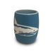 Introducing the Mote Marine Laboratory Etched Shark Shot Glass—a small blue ceramic cup adorned with a white shark illustration, set against a plain white background. This unique shot glass is an ideal keepsake for marine conservation enthusiasts and supporters of Mote Marine Laboratory.