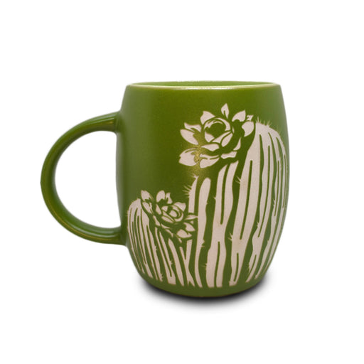 The Desert Botanical Garden Etched Mug features a green ceramic design with two white outlined cacti and succulent flowers inspired by Arizona native flora, making it a perfect botanical garden gift. The mug is displayed on a white background.
