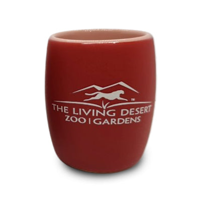 A clear shot glass featuring an elegant etched giraffe design and The Living Desert Zoo and Gardens logo—ideal for those who support giraffe conservation at the zoo or collectors seeking distinctive pieces like this Giraffe Etched Shot Glass.