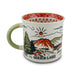The Garden of the Gods Feeling Folksy Mug is a ceramic mug inspired by Colorado Springs, featuring a painted landscape of mountains, trees, and the sun. It has a green handle, a red patterned interior, and is labeled “Garden of the Gods.”.