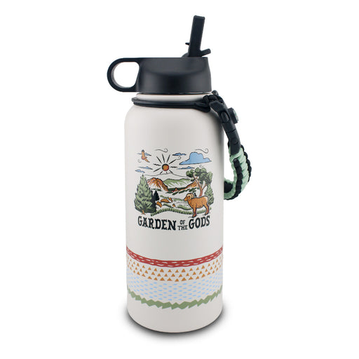 The Garden of the Gods Feeling Folksy Water Bottle is a white, eco-friendly bottle with a black lid, patterned bands, and a textured carrying handle. It showcases a colorful landscape illustration with mountains, sun, trees, animals, and the text “Garden of the Gods.”.