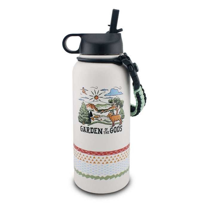 The Garden of the Gods Feeling Folksy Water Bottle is a white, eco-friendly bottle with a black lid, patterned bands, and a textured carrying handle. It showcases a colorful landscape illustration with mountains, sun, trees, animals, and the text “Garden of the Gods.”.