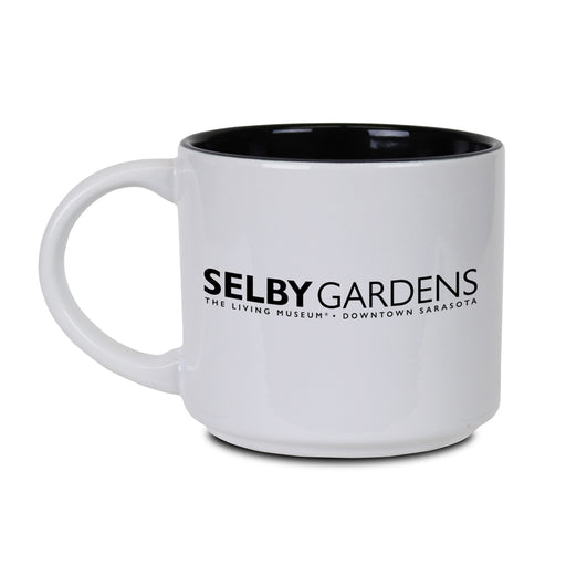 White ceramic Marie Selby Botanical Gardens Calder Nature of Movement Mug with black interior, featuring "SELBY GARDENS - THE LIVING MUSEUM - DOWNTOWN SARASOTA" printed in black on the side.