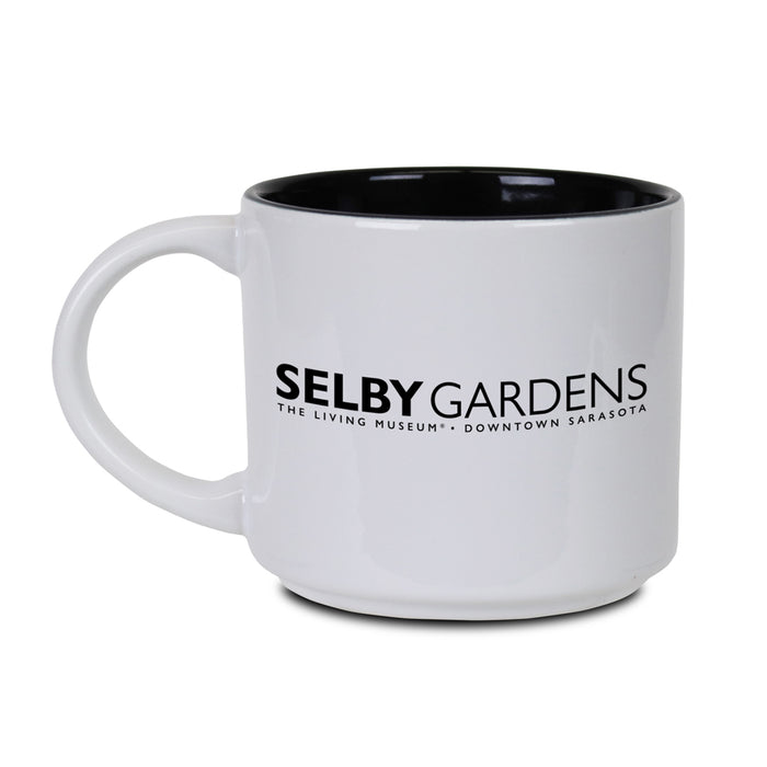White ceramic Marie Selby Botanical Gardens Calder Nature of Movement Mug with black interior, featuring "SELBY GARDENS - THE LIVING MUSEUM - DOWNTOWN SARASOTA" printed in black on the side.