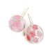 The Sakura Cherry Petal Earrings feature two round, clear resin discs with 24K gold plated hooks, each showcasing delicate pink cherry petals in varying shades beautifully arranged inside the transparent design.