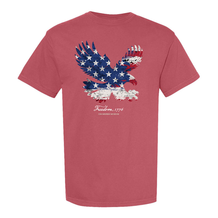 Sure! Here’s a rewritten version using the provided product data: Celebrate your love for naval aviation history with the USS Midway Museum America’s Birthday Eagle T-Shirt. This vibrant red tee showcases a flying eagle adorned with an American flag pattern. Beneath the bold graphic, the text reads: Freedom, 1776 and USA History Museum—making it a perfect tribute for proud visitors and enthusiasts of the USS Midway Museum.