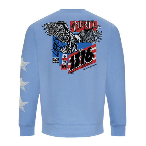 USS Midway Museum American Concert Tour Crew Sweatshirt in light blue, featuring three white stars on the sleeve. The back displays an eagle, red and white stripes, “AMERICA,” “Liberty,” “Since 1776,” and “250 Years with US Military Museum” text—celebrating American naval aviation history as seen at the USS Midway Museum in San Diego.