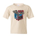 Celebrate in style with the USS Midway Museum American Birthday Concert Youth T-Shirt, featuring a beige design with an eagle graphic, vibrant American flag colors, and “America 1776” emblazoned on the front—perfect for the American Birthday Concert or as a memorable souvenir from your visit to the USS Midway Museum.