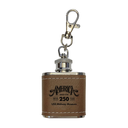 Introducing the USS Midway Museum America’s Birthday Concert Series Flask—a small brown leather flask keychain with “America Since 1776, United 250 Years, USS Midway Museum” printed on the front. It features a sturdy metal clasp at the top, making it an ideal keepsake for aviation enthusiasts and collectors celebrating naval aviation history from this iconic aircraft carrier museum.