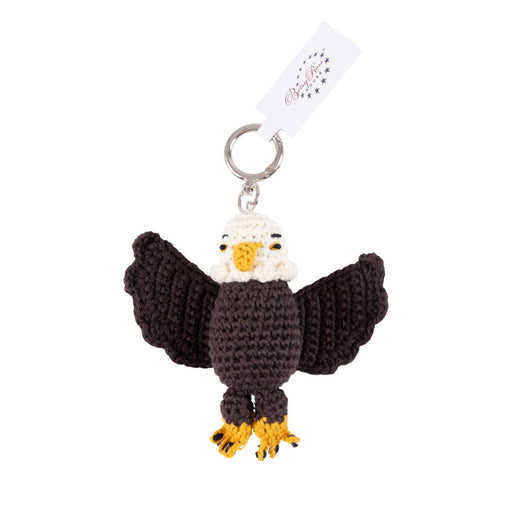 The Betsy Ross House Eagle Crocheted Bag Charm is a handcrafted keyring featuring a crocheted bald eagle with outstretched wings, yellow beak and feet, and a silver keyring attached to a white tag—perfect as a bag charm or thoughtful souvenir from the Betsy Ross House.
