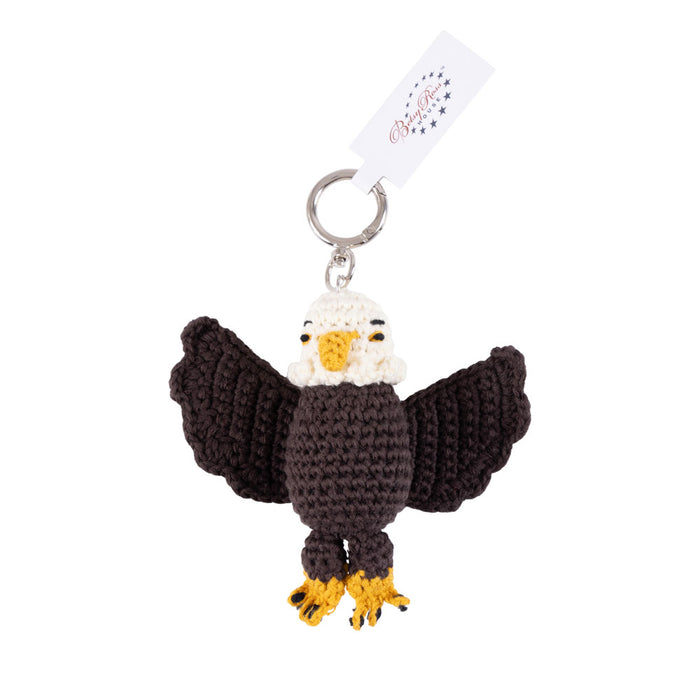 The Betsy Ross House Eagle Crocheted Bag Charm is a handcrafted keyring featuring a crocheted bald eagle with outstretched wings, yellow beak and feet, and a silver keyring attached to a white tag—perfect as a bag charm or thoughtful souvenir from the Betsy Ross House.