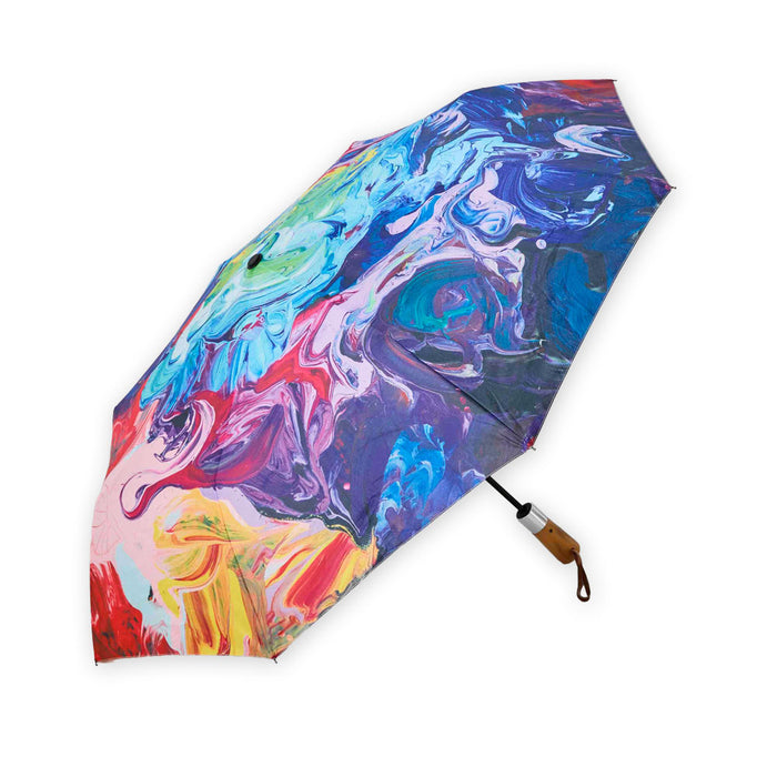 Painter’s Palette travel umbrella open to display a multi-colored abstract paint swirl pattern and a wooden handle.