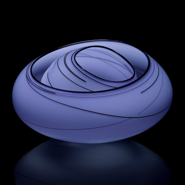 The 2026 Chihuly Studio Edition Pewter Blue Basket is an oval, handblown glass sculpture in lavender-blue with black swirls, set on a reflective black base—evoking the iconic style of Studio Edition Chihuly glass baskets.