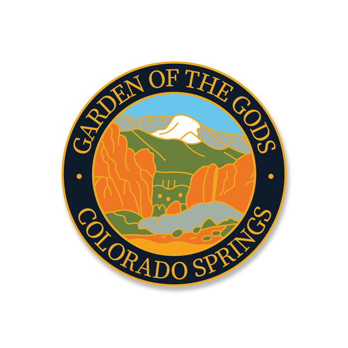 Circular badge with GARDEN OF THE GODS COLORADO SPRINGS around an illustration of red rock formations, green hills, and a snow-capped mountain under a blue sky—a stunning tribute to one of Colorado’s most iconic landmarks. The perfect keepsake, this Garden of the Gods Gateway Rocks Pin is ideal for commemorating your visit during the 150th Anniversary celebration.