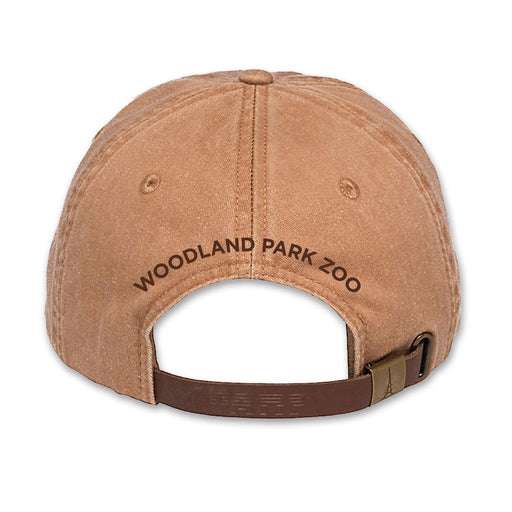 A tan Woodland Park Zoo Baby Lion Cap viewed from the back, featuring "WOODLAND PARK ZOO" embroidered above an adjustable strap with a metal buckle—a great pick for wildlife conservation supporters.