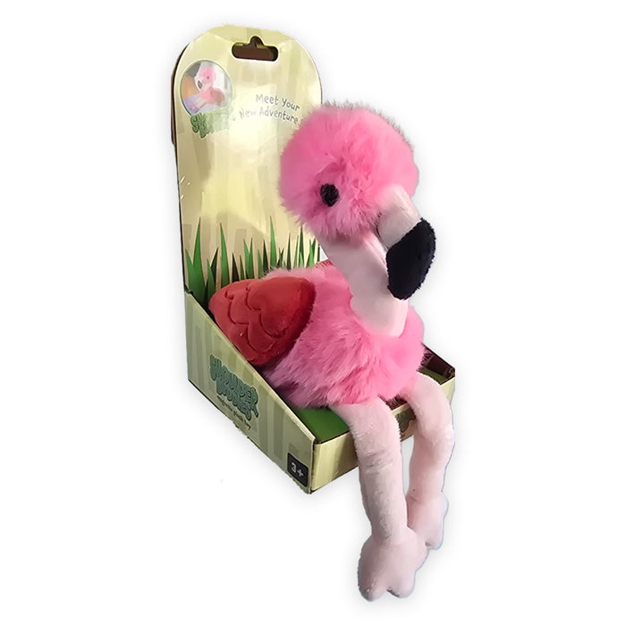 A bright pink Flamingo Shoulder Buddy plush with long legs sitting inside its open cardboard packaging.