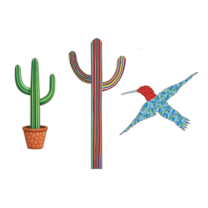 Featuring three whimsical designs—a potted green cactus, a rainbow-striped tall cactus with arms, and a mosaic-patterned flying hummingbird with a red head and blue wings—each pin in the Desert Botanical Garden Will Beger Pin Set celebrates desert flora on a crisp white background. This vibrant trio beautifully captures the playful style and creative spirit of the Desert Botanical Garden.