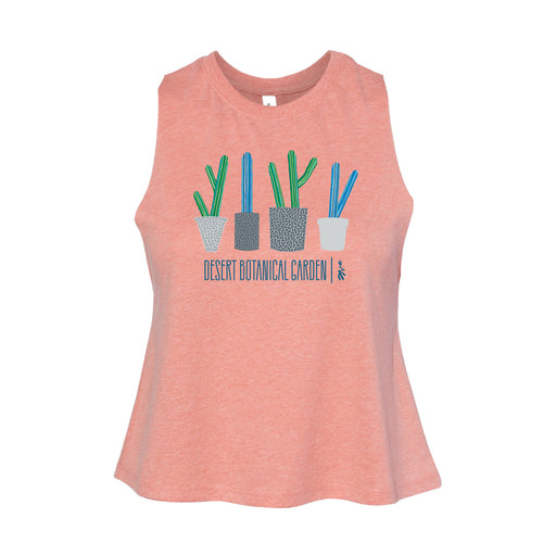 The Desert Botanical Garden Will Beger Cacti Lineup Women's Tank is a peach-colored, sleeveless top featuring four illustrated potted cacti above blue "Desert Botanical Garden" text, designed in collaboration with Will Beger.