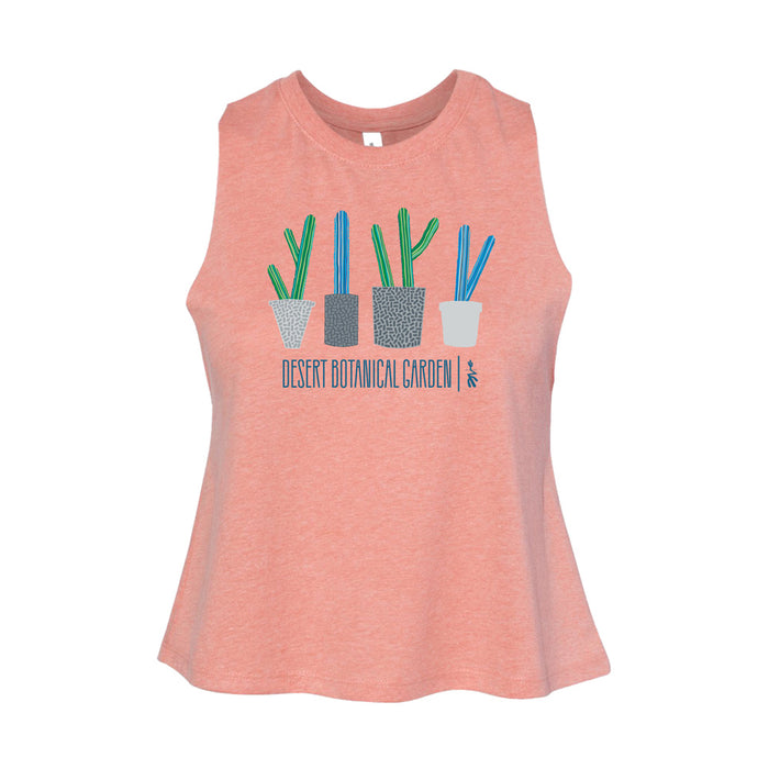 The Desert Botanical Garden Will Beger Cacti Lineup Women's Tank is a peach-colored, sleeveless top featuring four illustrated potted cacti above blue "Desert Botanical Garden" text, designed in collaboration with Will Beger.