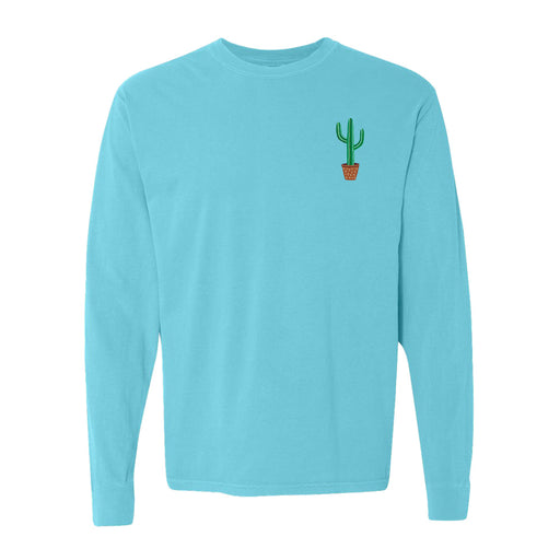 The Desert Botanical Garden Will Beger Cactus T-Shirt is a light blue long-sleeve shirt featuring a small, minimalist green cactus in a brown pot graphic on the upper left chest—an ideal choice for fans of simple style and the unique charm of the Desert Botanical Garden.