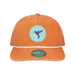 The Desert Botanical Garden Will Beger Hummingbird Patch Cap is an orange cap featuring a white rope above the brim and a circular patch with a blue and red hummingbird, designed by Will Beger. It also includes a green Skully brand sticker on the brim.