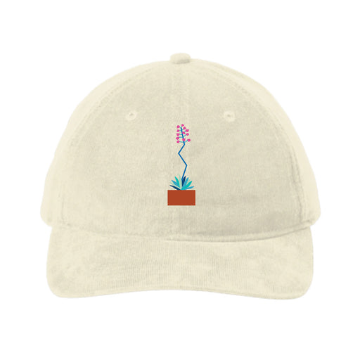 Introducing the Desert Botanical Garden Will Beger Embroidered Agave Flower Cap—a beige baseball cap centered with a small, embroidered potted plant featuring green leaves, a blue stem, and pink flowers. Inspired by Will Beger’s appreciation for the Desert Botanical Garden, this cap adds subtle botanical charm to your everyday style.