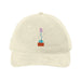 Introducing the Desert Botanical Garden Will Beger Embroidered Agave Flower Cap—a beige baseball cap centered with a small, embroidered potted plant featuring green leaves, a blue stem, and pink flowers. Inspired by Will Beger’s appreciation for the Desert Botanical Garden, this cap adds subtle botanical charm to your everyday style.