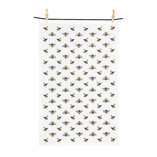 A white, eco-friendly kitchen towel from the Bees Dishcloth & Kitchen Towel Set hangs on a line, decorated with a repeating yellow and black bee pattern.