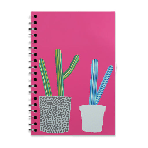 Introducing the Desert Botanical Garden Will Beger Green & Blue Cactus Notebook—a spiral-bound notebook with a bright pink cover adorned with two illustrated potted cacti: one nestled in a patterned gray pot and the other in a simple white pot, inspired by the vibrant flora of the Desert Botanical Garden.