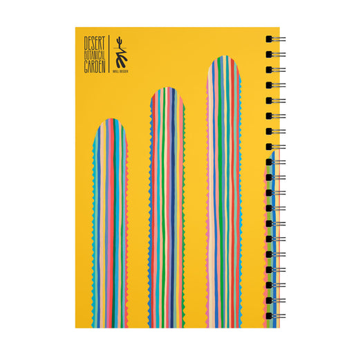 Desert Botanical Garden Will Beger Rainbow Cactus Notebook featuring a yellow spiral binding and the "Desert Botanical Garden" text in black. The cover showcases three tall, rounded cactus forms with vibrant vertical stripes and wavy edges, inspired by desert flora.