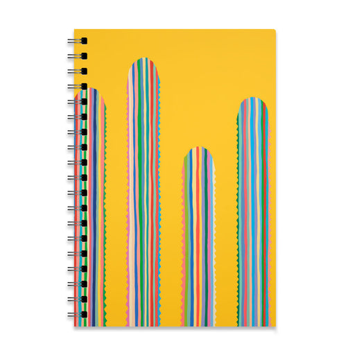A spiral-bound Desert Botanical Garden Will Beger Rainbow Cactus Notebook with a yellow cover featuring four tall, rounded shapes adorned with multicolored vertical stripes, inspired by vibrant desert flora and resembling abstract cacti.