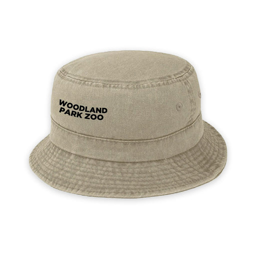 The Woodland Park Zoo Jason LaClair Frog Youth Bucket Cap, designed by Indigenous artist Jason LaClair, comes in tan with "WOODLAND PARK ZOO" printed in black on the front and is shown on a plain white background.