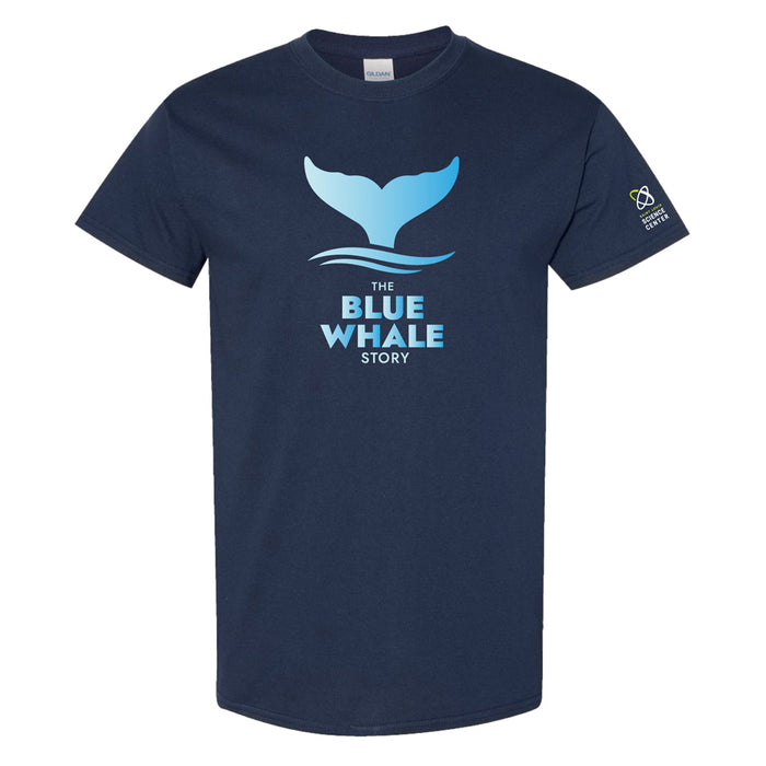 Navy blue t-shirt with a light blue whale tail graphic above stylized waves and the text THE BLUE WHALE STORY on the front. A small logo is on the left sleeve.